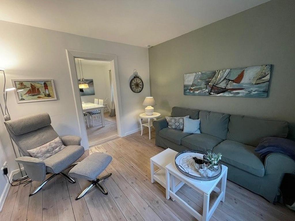 a living room with a couch and a table at Brise 5 in Büsum