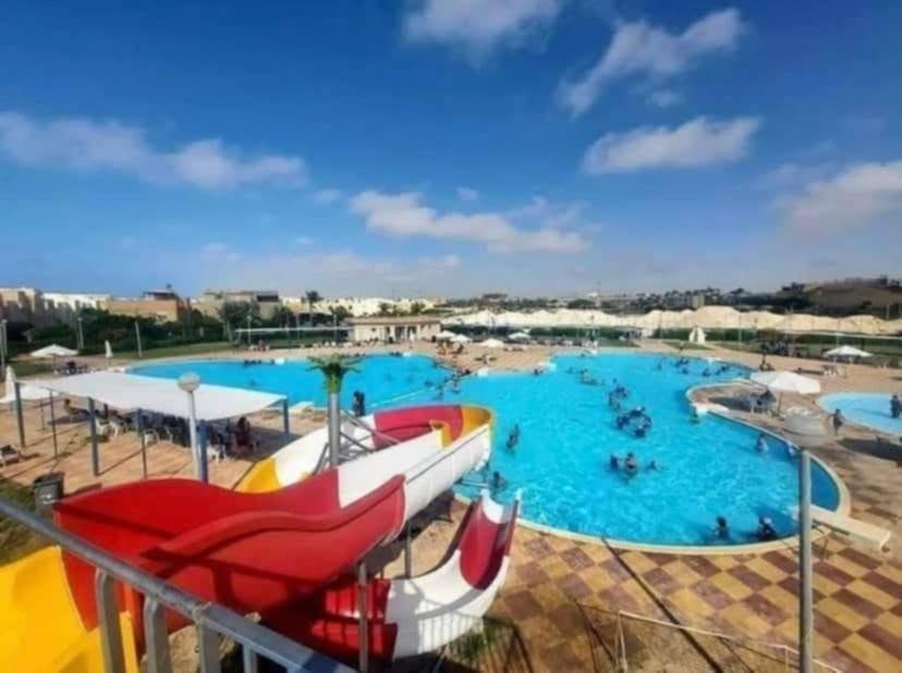 a large water park with a large swimming pool at ڤيلا صاحبه السعاده قريه بدر الساحل الشمالي in El Alamein