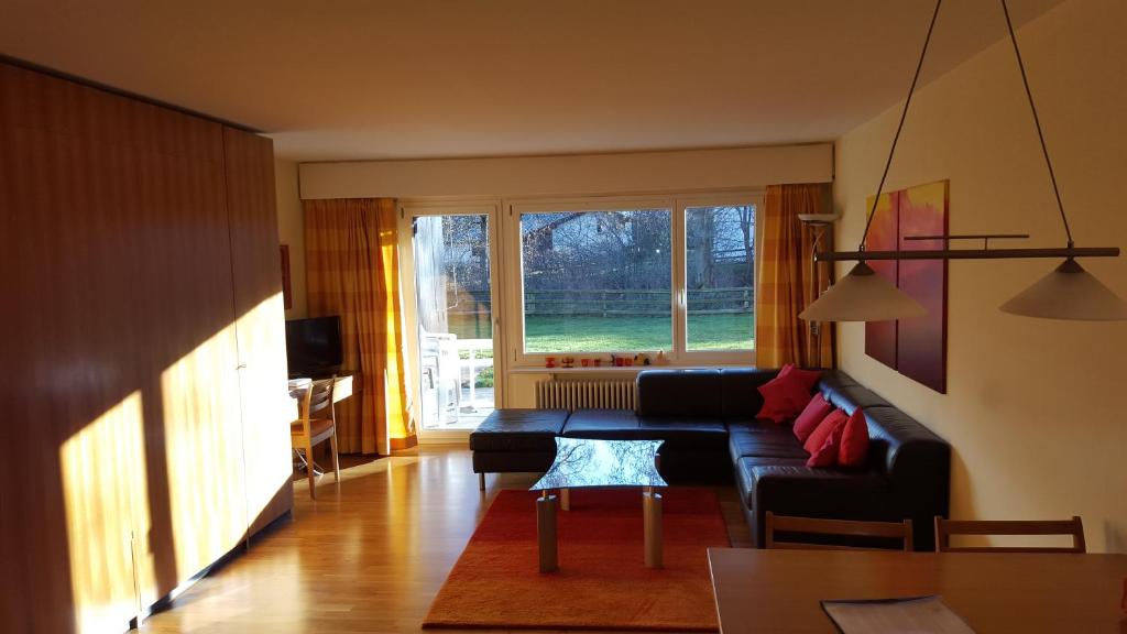 a living room with a couch and a window at Alpen-Fewo, Residenza Quadra 25 in Flims