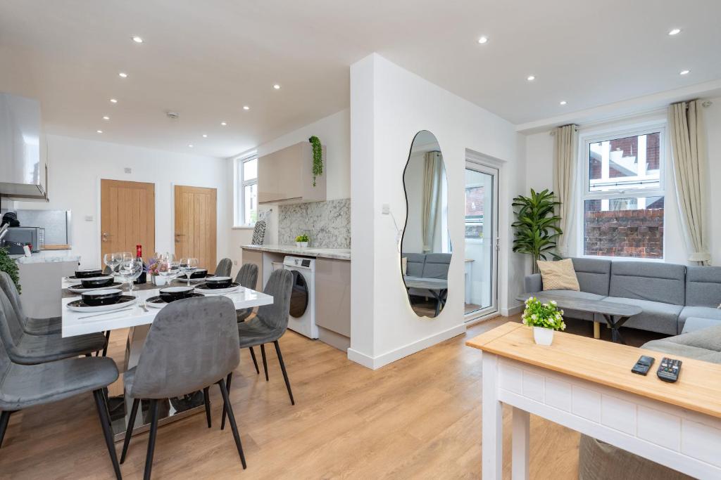 a kitchen and living room with a table and a dining room at Open Mind Property- Stylish 3BR, HotTub & Parking in Portsmouth