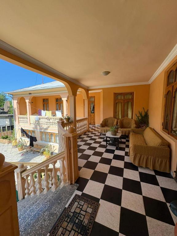 a living room with a checkered floor at Guest House Gio in Gonio