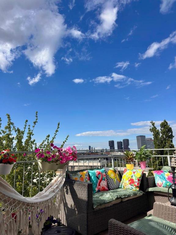 a couch on a balcony with a view of the city at Apartment with a terrace in Vienna