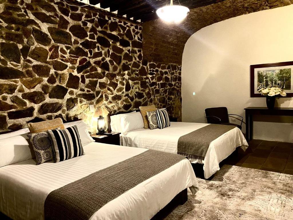 Postel nebo postele na pokoji v ubytování HOTEL MINA REAL