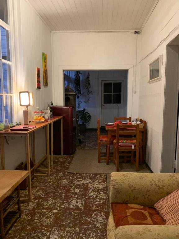 a living room with a couch and a table at Hospedaje en borde río in Valdivia