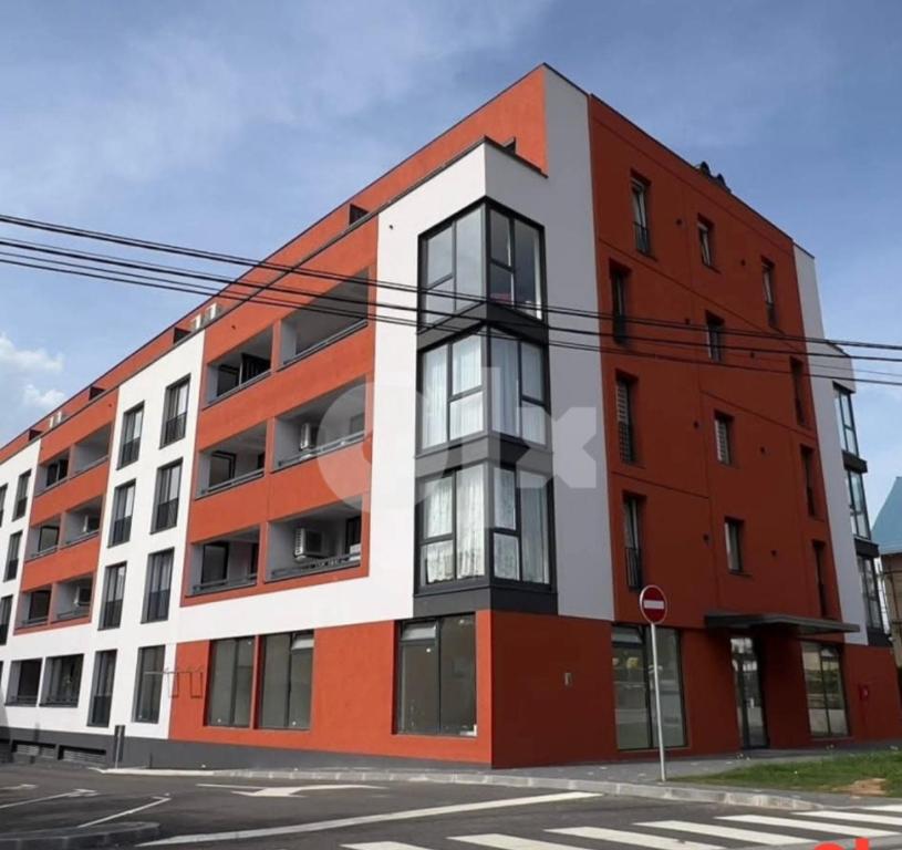 an orange and white building on the corner of a street at Luxury Apartment Sarajevo Free parking in Sarajevo