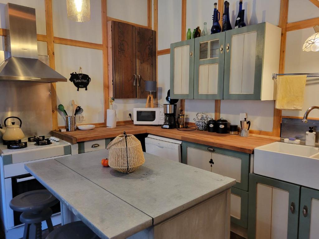 a kitchen with green cabinets and a counter top at Loft Apartment at Moulin SAGE in Treignac