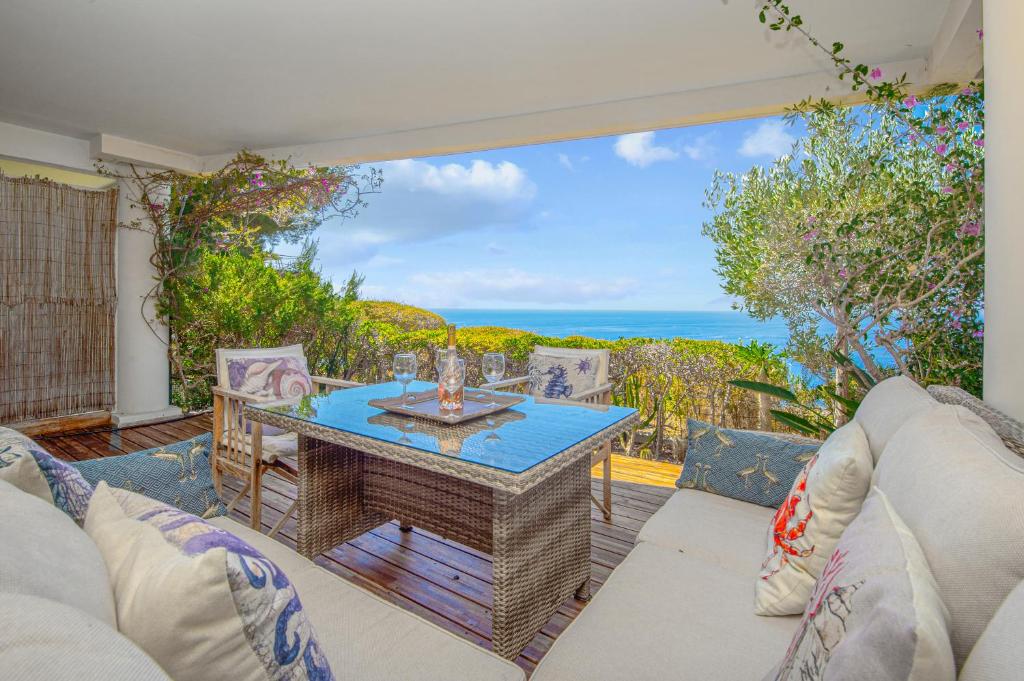 a living room with a table and a view of the ocean at Le Chevalier in Cap d'Ail