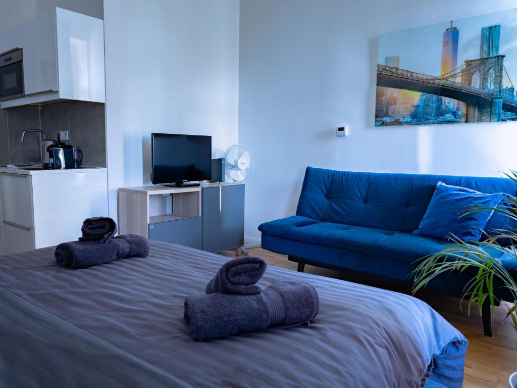a living room with a bed and a couch at Central Studio by Museum and Old Town in Prague