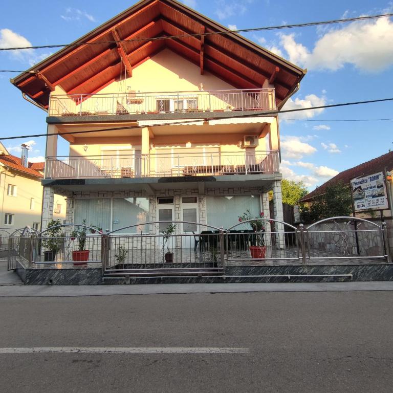 a house with a roof on the side of a street at Prenoćiste Borik in Sanski most