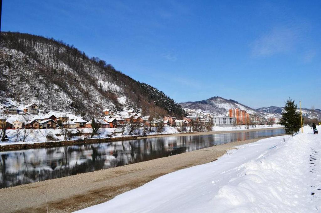 a snow covered river with houses and a city at Hotel Royal Drina in Mali Zvornik