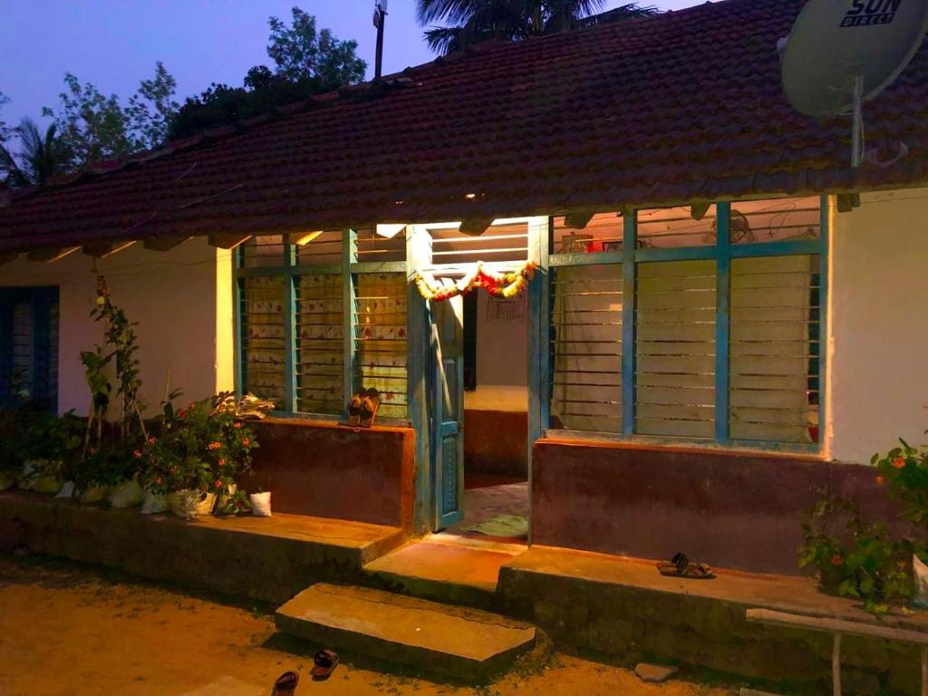 a house with a front door with a window at Village House in Blegod