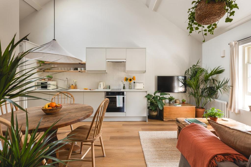 a kitchen and living room with a table and chairs at Leworth Apartments, Windsor in Windsor