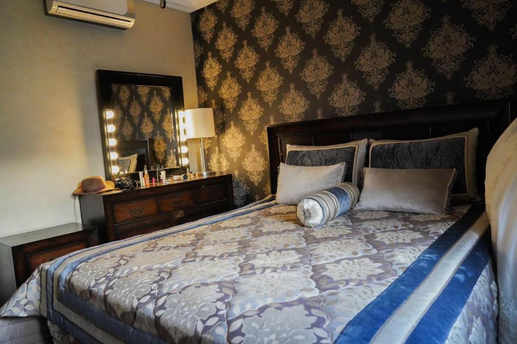 a bedroom with a large bed and a mirror at Arina beach martil in Martil