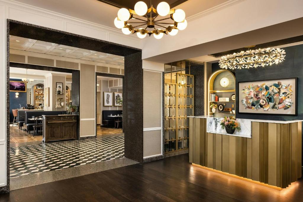 a lobby of a hotel with a chandelier at The Talbott, Autograph Collection in Chicago