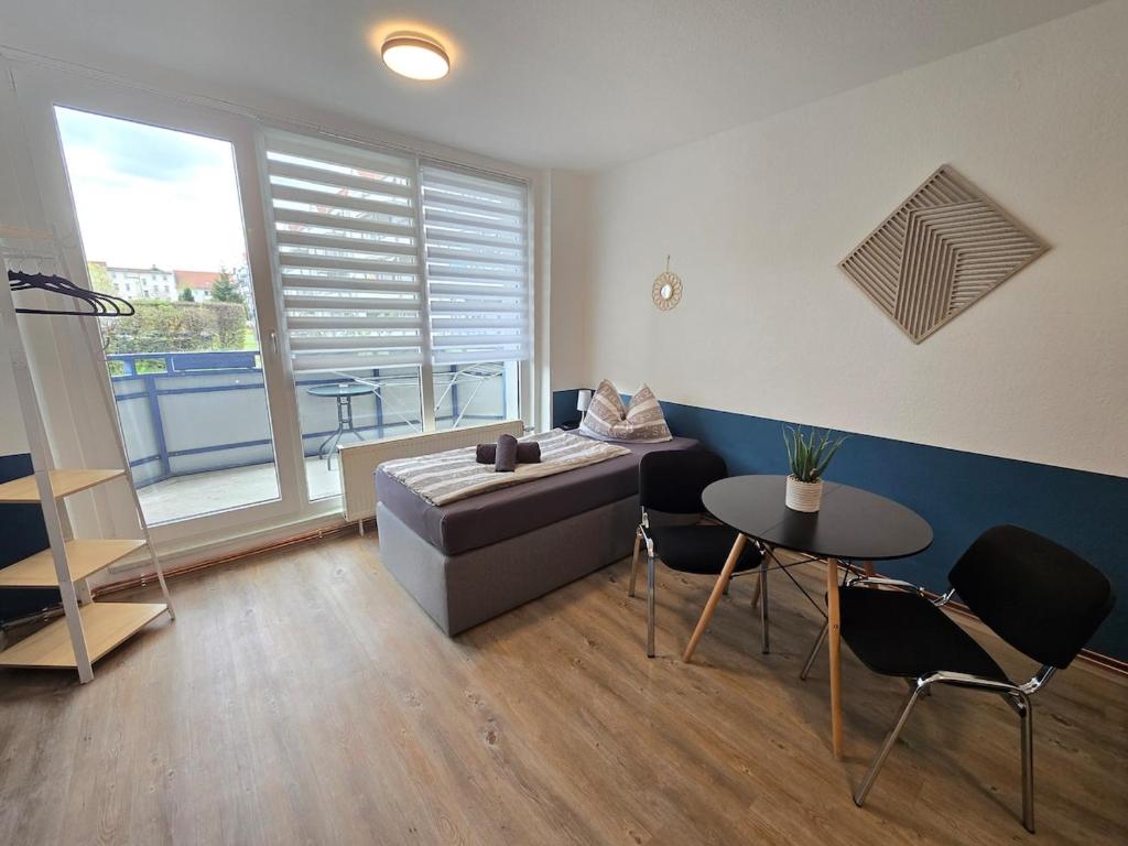a living room with a couch and a table at FeWo 5 Personen, Nähe Bahnhof, WLAN,Balkon in Halberstadt