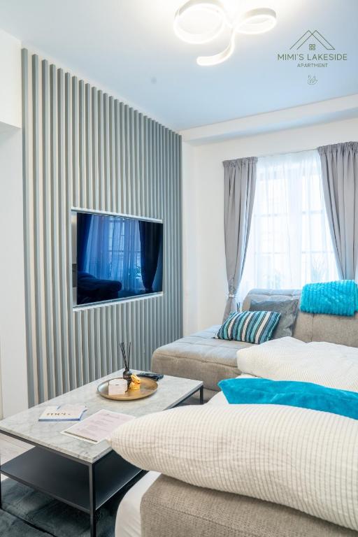 a living room with a couch and a table at MIMIs Lakeside Apartment - NEWLY RENOVATED in Gmunden