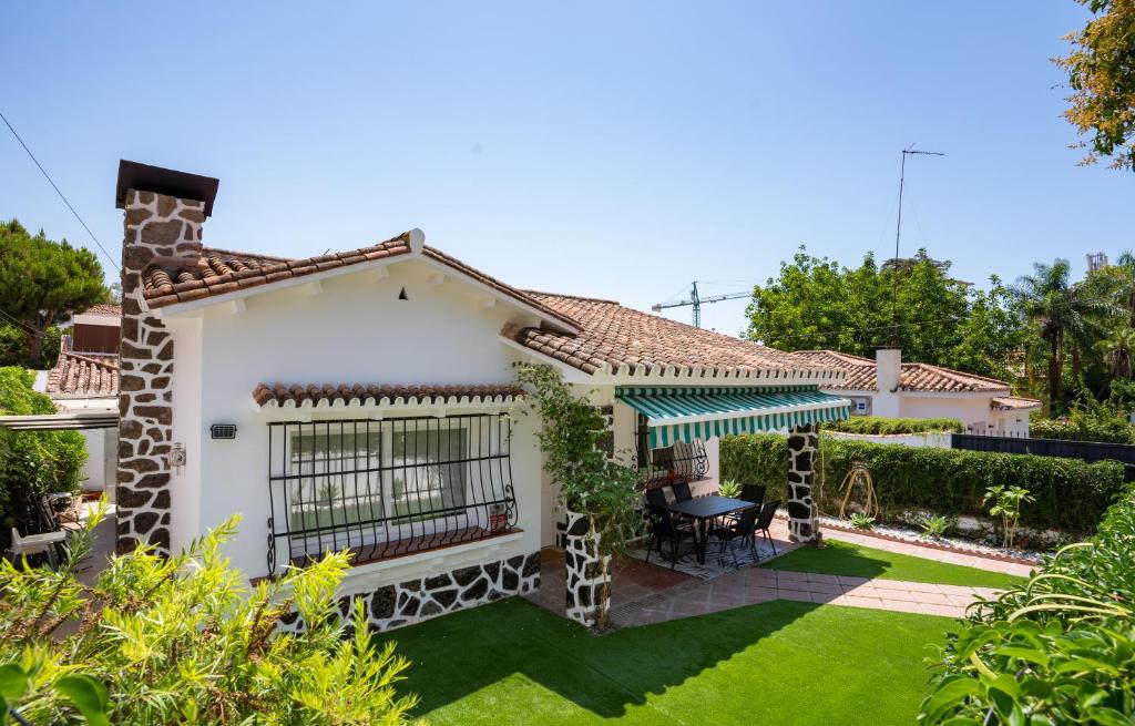 a white house with a garden and a lawn at Spacious Malaga House with private walled-in yard in Málaga