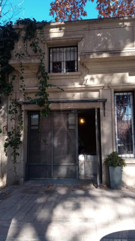a building with a garage with a gate in front at Loft Rufino in Mendoza