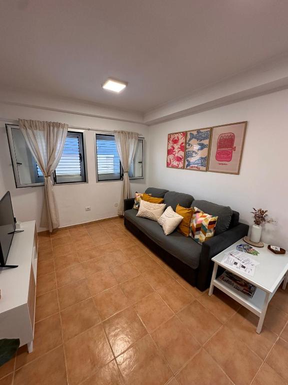 a living room with a couch and a table at Sardina Serena in Gáldar