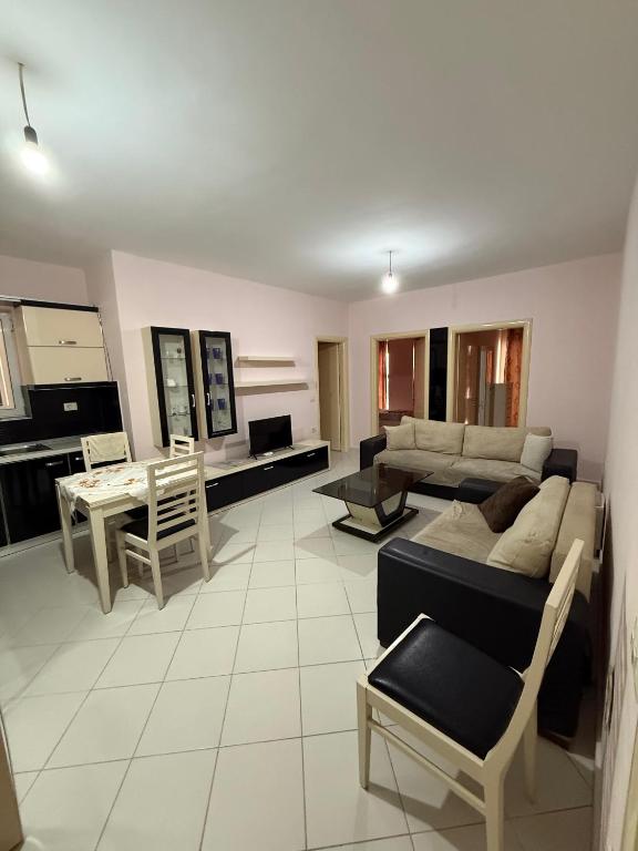 a living room with a couch and a table at Apartament Lola in Pogradec
