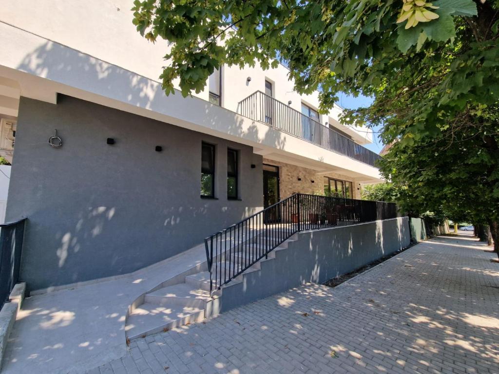 a building with a staircase in front of it at Rosiem Boutique in Techirghiol