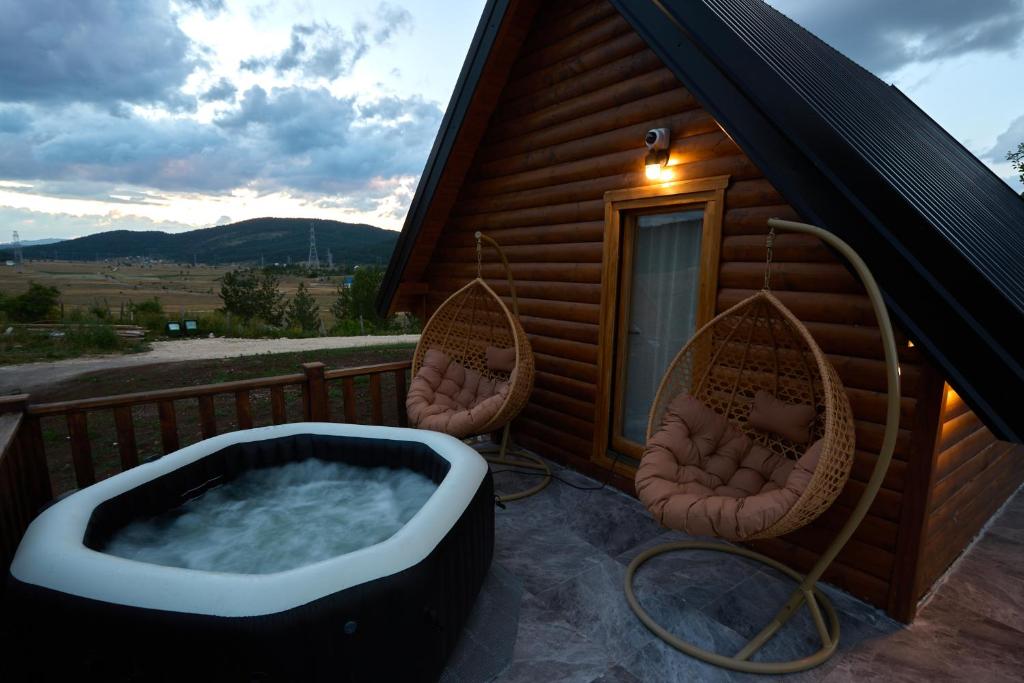 a hot tub on the deck of a cabin at Arhetip, Kikina Villa in Njegovuđa