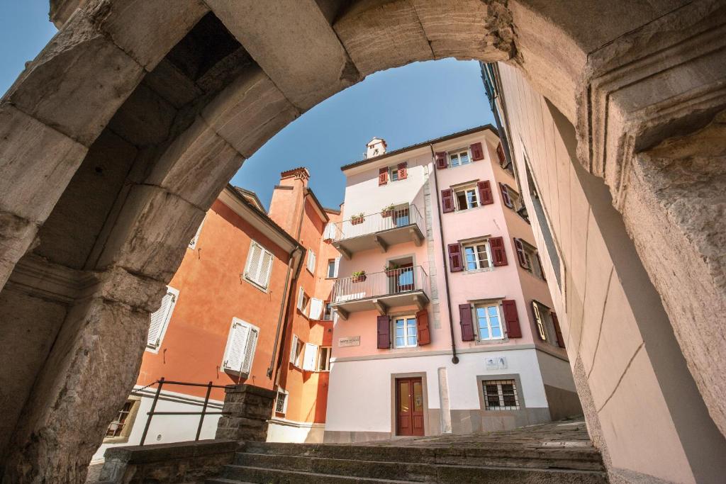 a view of a building through an archway at Hotel All'Arco in Trieste