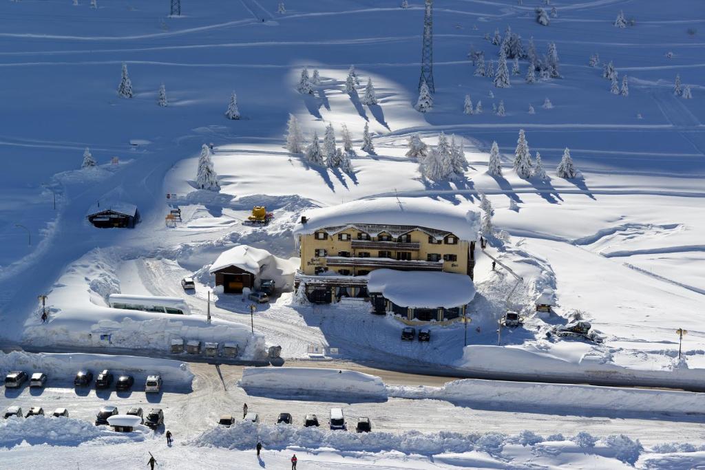 a building in the snow on a ski slope at Hotel Dolomiti in Passo del Tonale