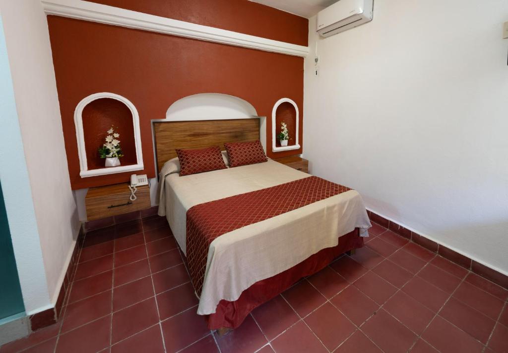 Postel nebo postele na pokoji v ubytování Hotel Encino Malecón Centro Puerto Vallarta