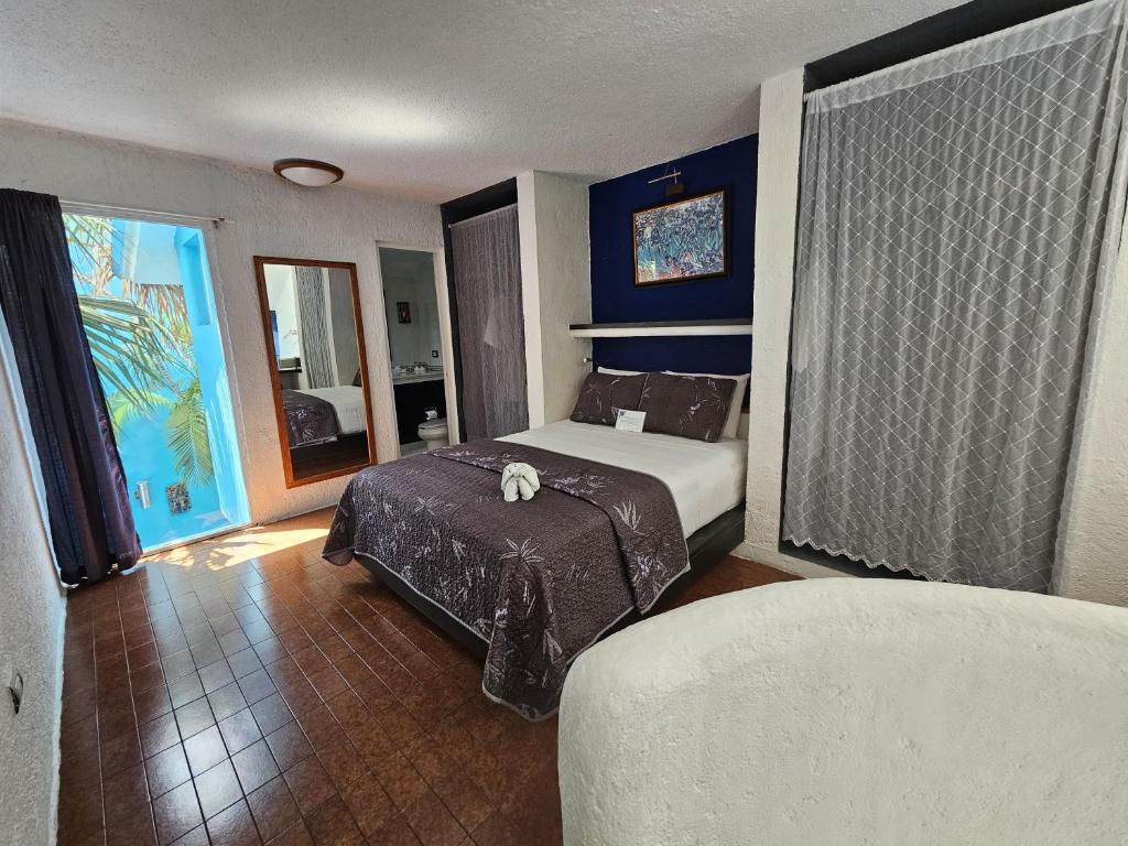 Postel nebo postele na pokoji v ubytování Hotel Villas Las Anclas