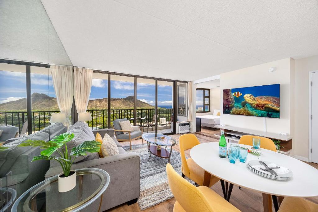 a living room with a couch and a table at 34th floor lanai with Diamond Head views, pool & hot tub access in Honolulu