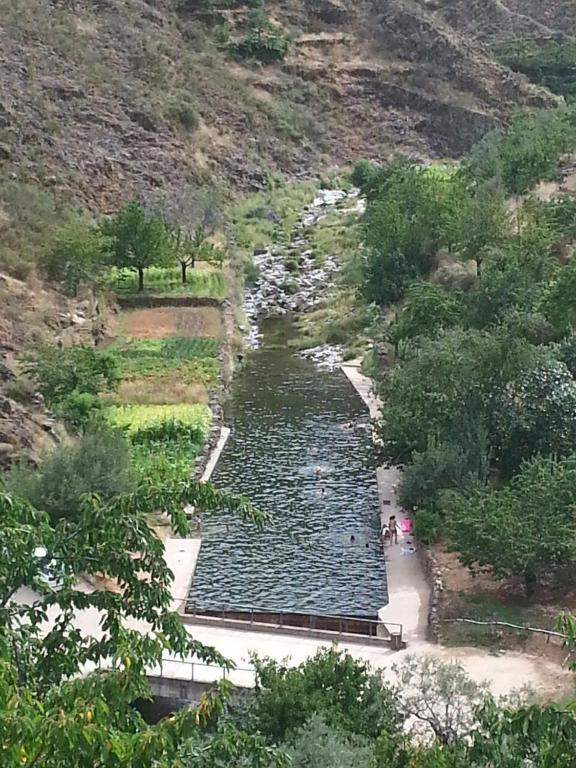 a view of a river with people in it at Alojamientos Rurales Hurdes Altas in Casares de las Hurdes