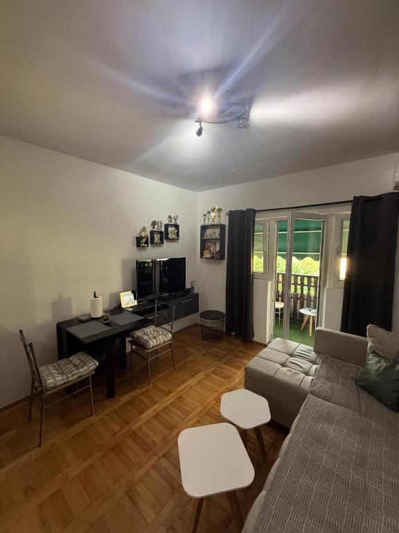a living room with a couch and a table at Stan na dan Despotovac in Despotovac