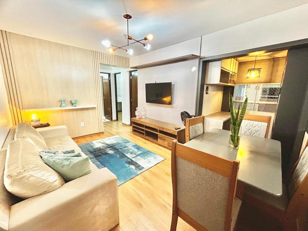 a living room with a couch and a table at Apart Zen Santa Inês in Imperatriz