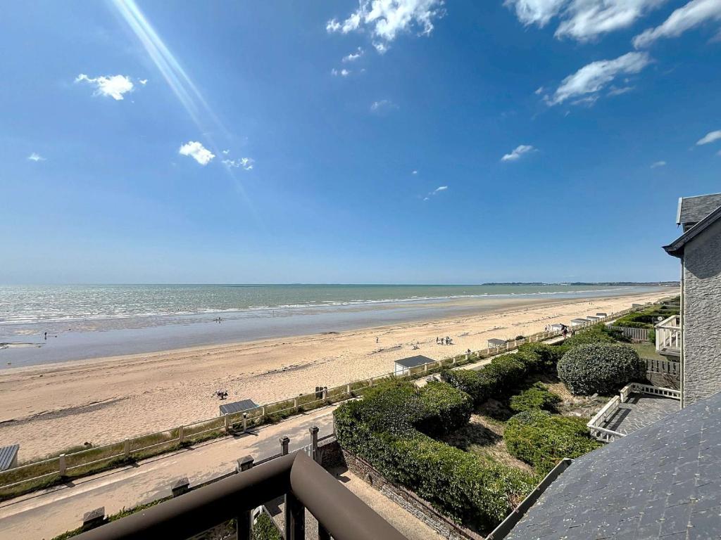 a view of the beach from the balcony of a condo at Appartement en bord de mer, 1 chambre, 4 couchages, parking privé - FR-1-361-570 in Jullouville-les-Pins