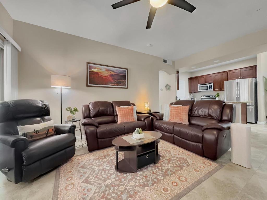 a living room with leather furniture and a ceiling fan at Southern #1114 Mesa in Mesa