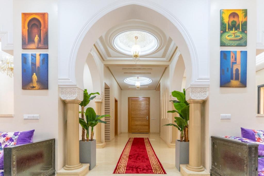 a hallway in a building with paintings on the walls at Peaceful Marrakech Villa 4 Bedrooms Private Pool in Marrakech