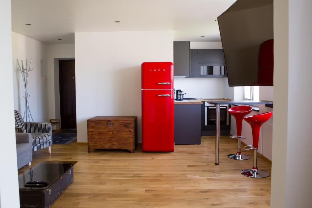 a kitchen with a red refrigerator in a room at Uus Street 34 Apartment in Kuressaare