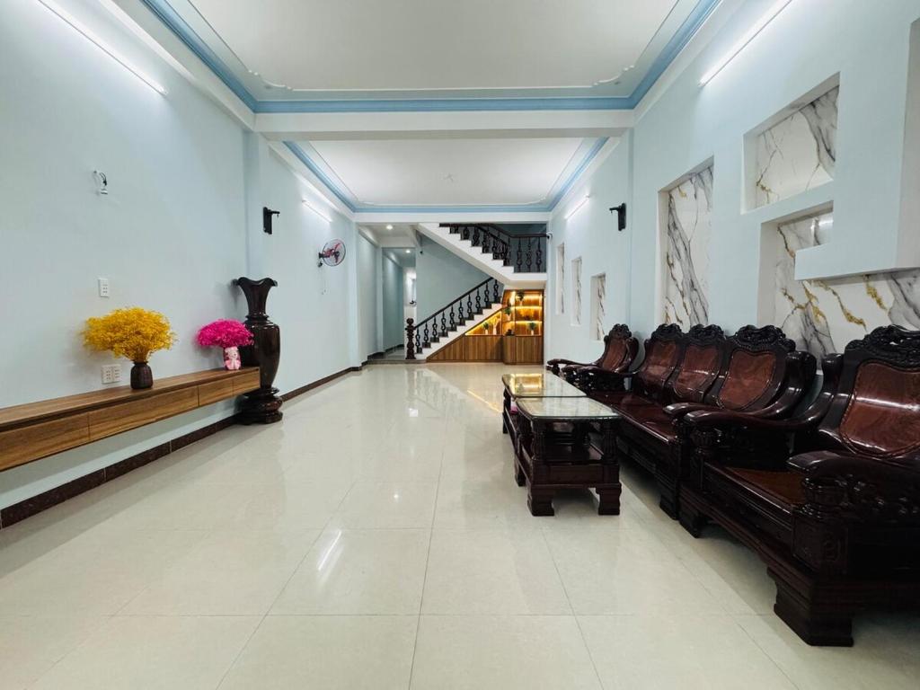a living room with a couch and a staircase at Beachside Home, Ngũ Hành Sơn, Đà Nẵng in Da Nang