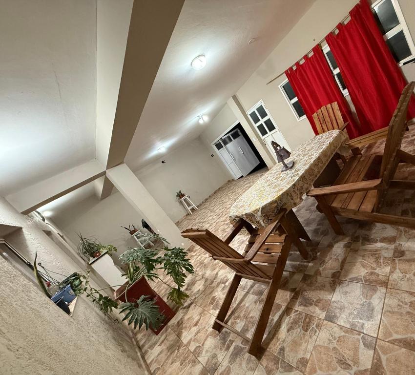 a living room with a wooden table and a bench at Casa Tomas 2 in Villa Unión