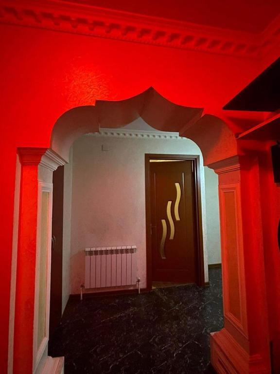 a red room with a red wall and a door at flat in Itʼkhvisi