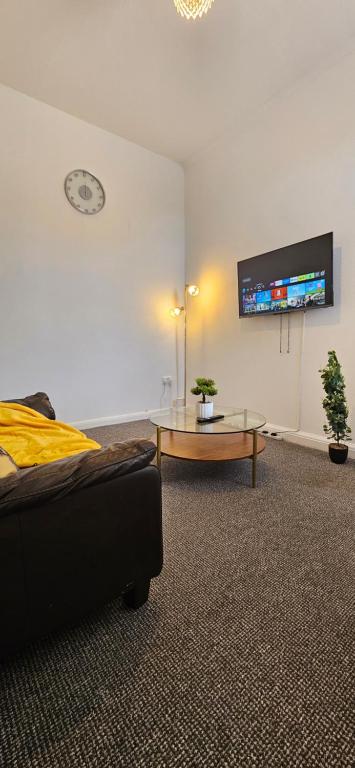 a room with a bed and a table and a tv at OG Stays V in Pallion