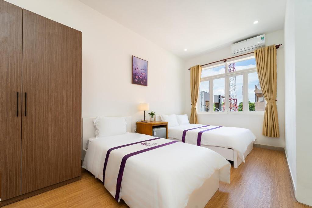 Postel nebo postele na pokoji v ubytování The Sim Hotel Vung Tau