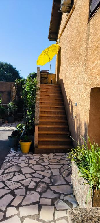 a yellow umbrella sitting on top of a stair case at appartement proche zenith in Montpellier