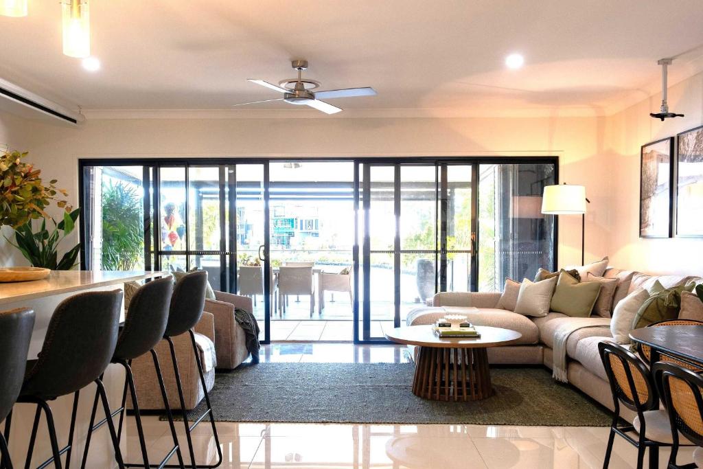 a living room with a couch and a table at Waterfront Stay at Sunshine Villa in Maroochydore