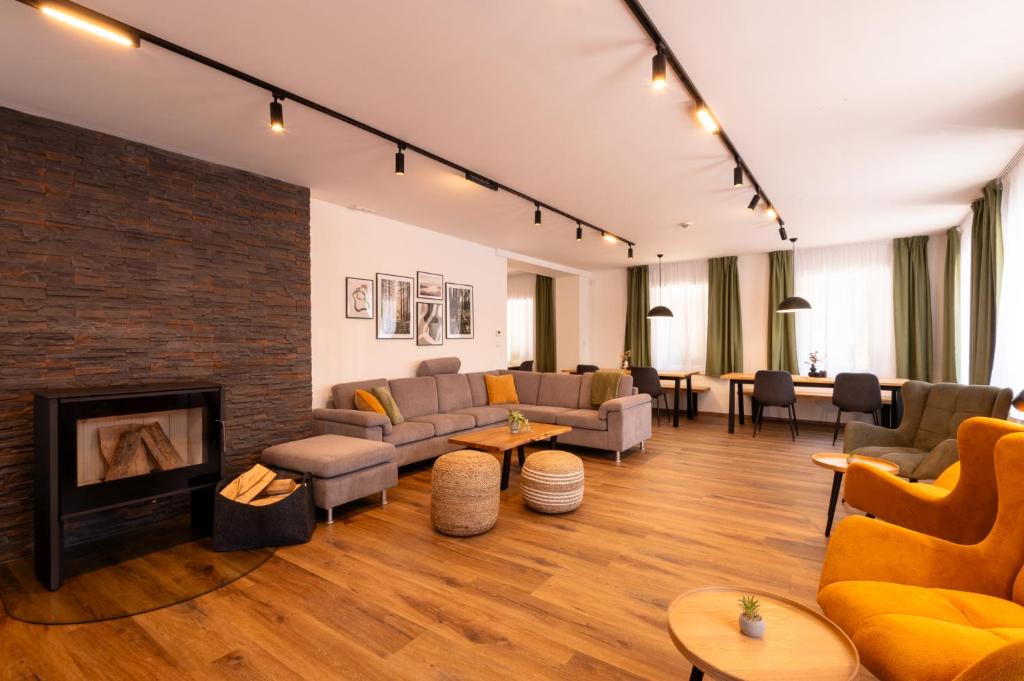 a living room with couches and a fireplace at Aberto Jizerky in Albrechtice v Jizerských horách