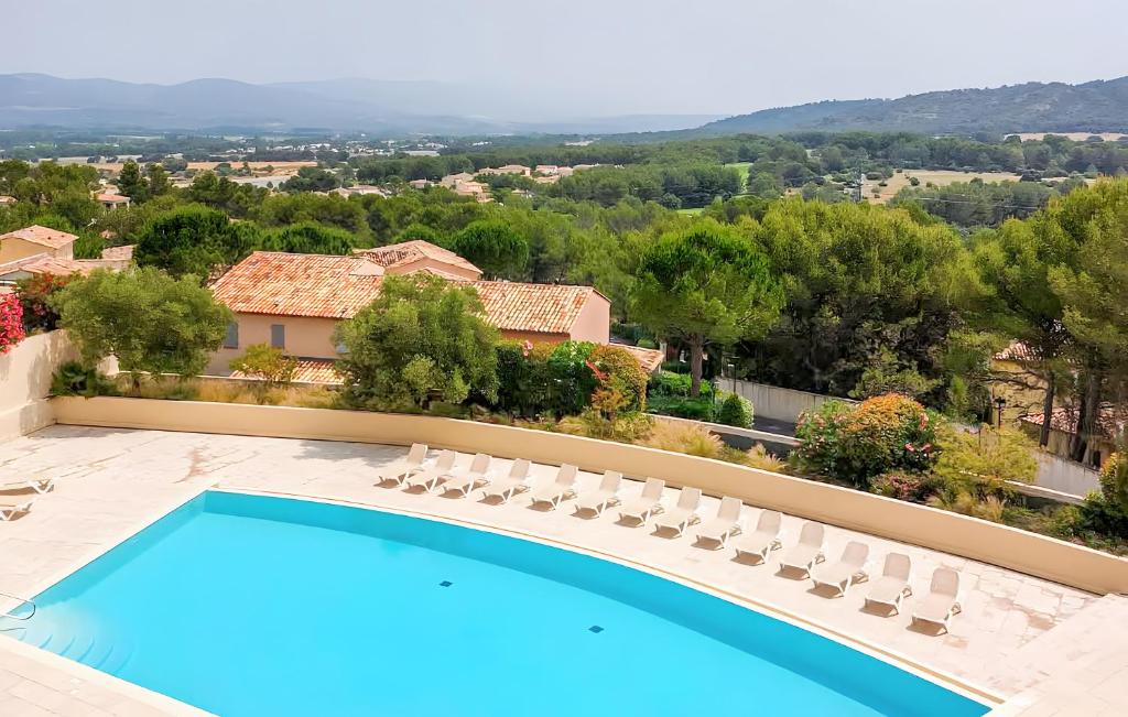 a villa with a swimming pool and chairs at Le Mas de Masha sur le Golf de Port in Mallemort