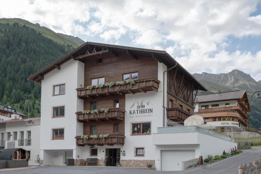 a large building with a sign on the side of it at Beim Kathrein - inklusive SILVRETTA Card Premium in Galtür