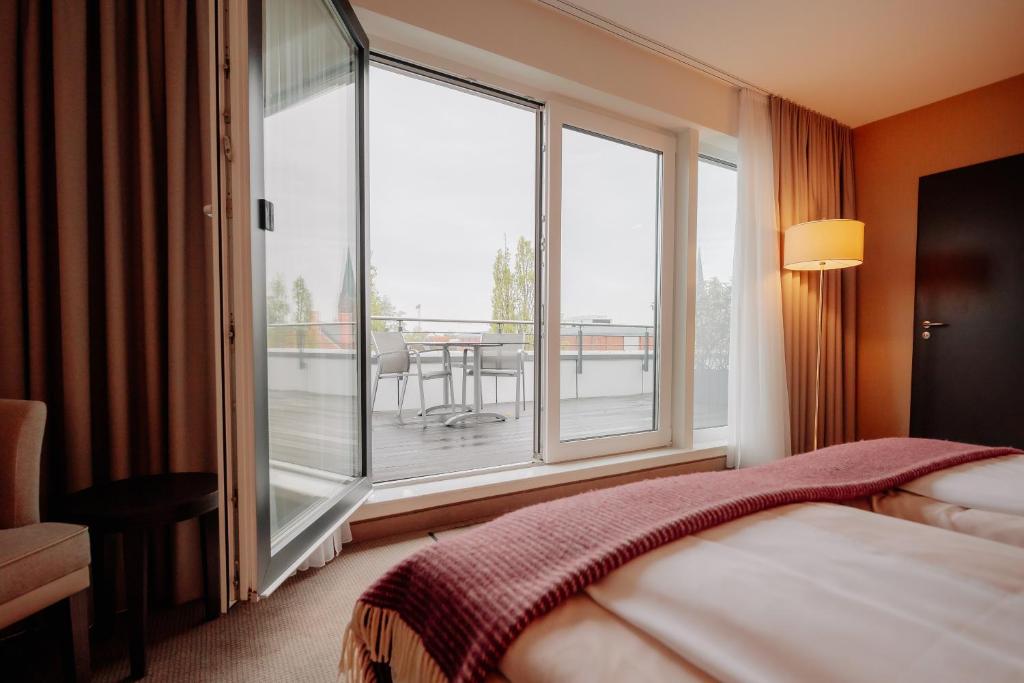 Postel nebo postele na pokoji v ubytování LOOKEN INN Lingen by Hackmann
