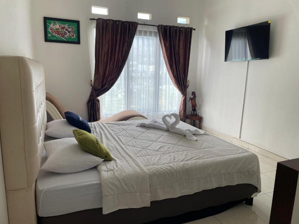 Postel nebo postele na pokoji v ubytování Urbanview Resort Syariah Khansa Cisarua Puncak by RedDoorz